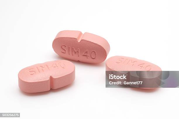 Three Simvastatin Tablets Stock Photo - Download Image Now - Statin, Cut Out, Editorial