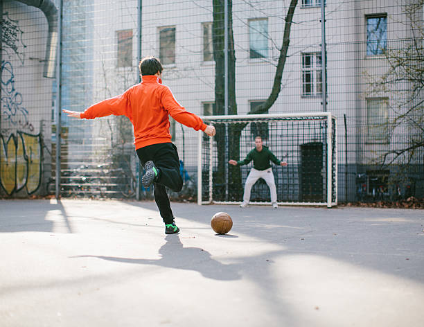 istock Young men playing soccer in the city 503256473