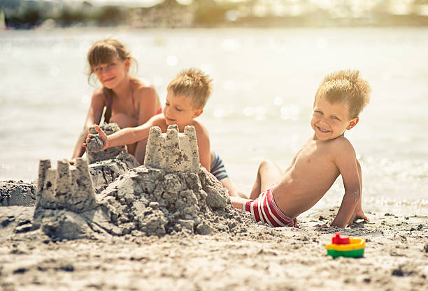 istock Kids building a sandcastle 503257427