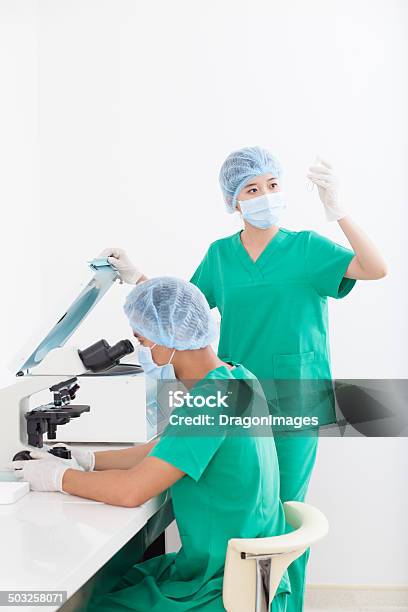 Examining Medical Tests Stock Photo - Download Image Now - Adult, Adults Only, Analyzing