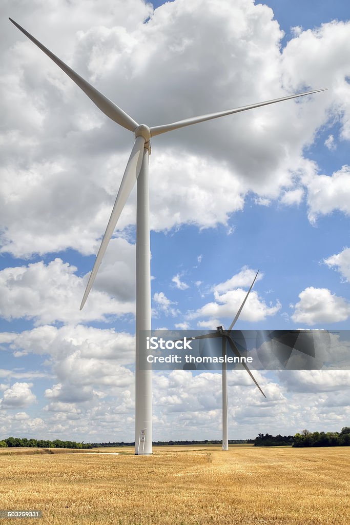 wind turbines wind turbine blades on blue cloudy sky background Backgrounds Stock Photo