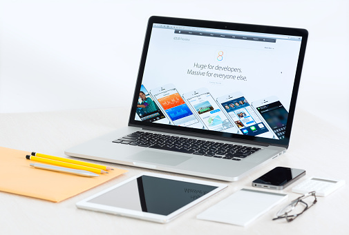 Lleida, Spain - February 28, 2023 : Studio photo of the new gray Apple iPad, logo from rear view and charger . Isolated on gray background. Illustrative editorial content.