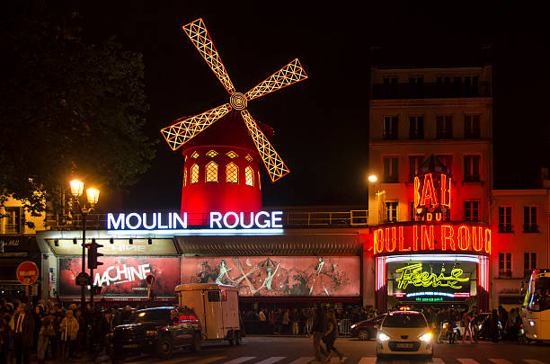 Moulin Rouge - Paris Paris, France - April 30, 2014: Moulin Rouge - Paris. The Moulin Rouge by night, on April 30, 2014 in Paris, France. Moulin Rouge is a famous cabaret built in 1889, locating in the Paris red-light district of Pigalle place pigalle stock pictures, royalty-free photos & images