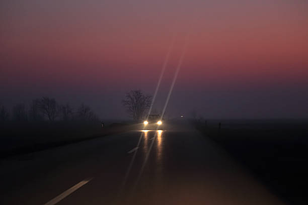Car on the night road at the sunset stock photo