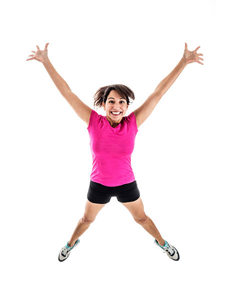 Young Female in Workout Wear Jumping for Joy stock photo