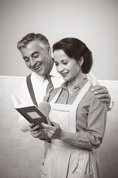 istock Wife and husband reading a cookbook together 503269900