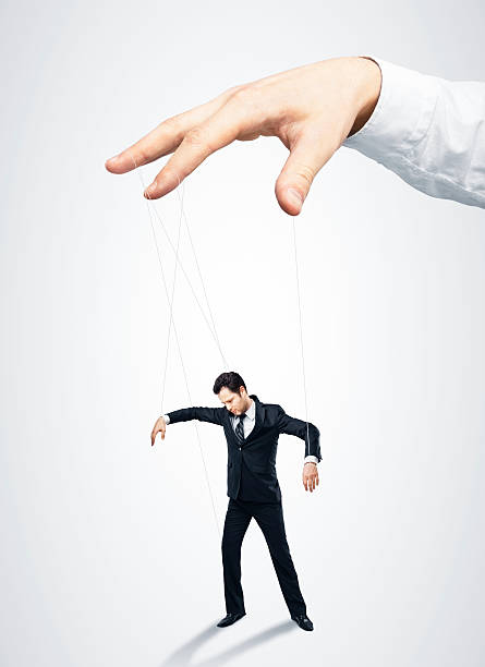 Businessman marionette Businessman marionette on ropes controlled  hand Marionette stock pictures, royalty-free photos & images