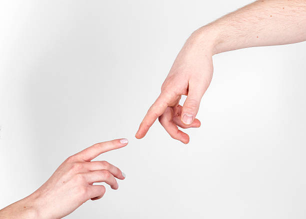 istock Fingers of Two People Nearly Touching 503275718