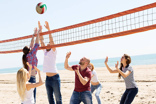 istock People play volleyball on beach 503277316
