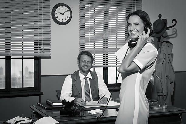 istock Young vintage secretary holding phone receiver 503278090