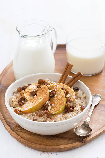 istock healthy breakfast - oatmeal with apples, raisins, cinnamon 503279502