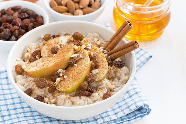 istock oatmeal with apples, raisins and cinnamon for breakfast, closeup 503279796