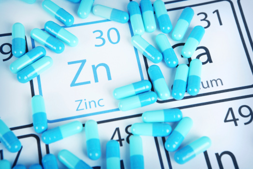 Zinc with capsules or pills on the periodic table (Periodic table made by me)  Stock image representing mineral supplementation.