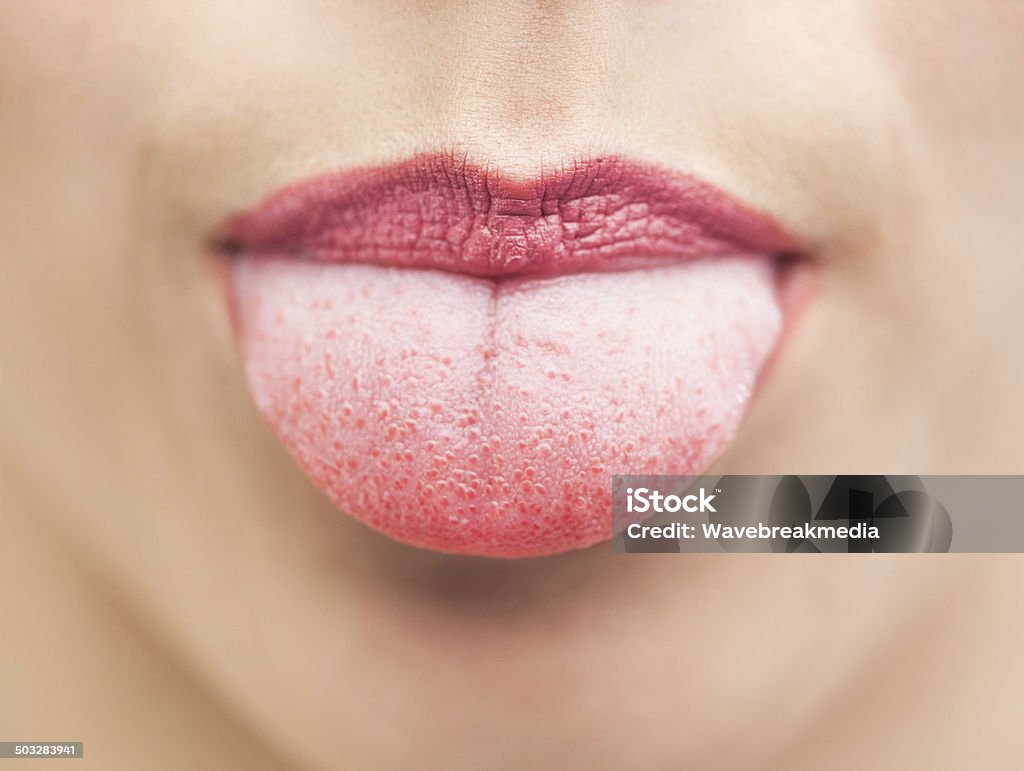 Extreme close up on beautiful mouth tongue out Extreme close up on beautiful cheeky mouth tongue out Sticking Out Tongue Stock Photo