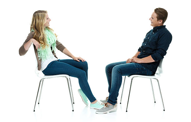 istock Two smiling people sitting on chair 503284373