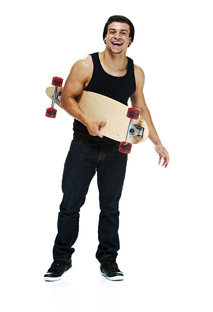 istock Cheerful man holding skateboard & looking at camera 503284381