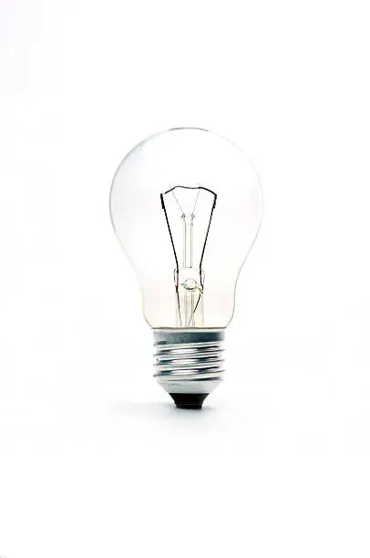 Photo of vintage lighted bulb  isolated on white background