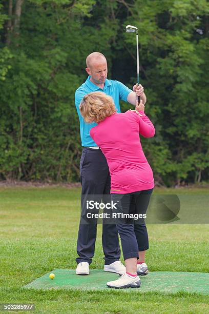 Golf Pro Correcting A Lady Golfers Grip Stock Photo - Download Image Now - Activity, Adult, Beginnings