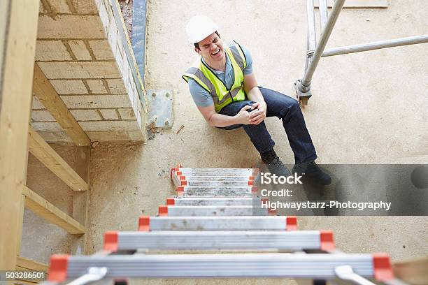 Construction Worker Falling Off Ladder And Injuring Leg Stock Photo - Download Image Now