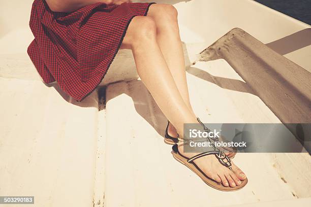 The Legs Of A Young Woman In A Boat Stock Photo - Download Image Now - Sandal, Women, One Woman Only