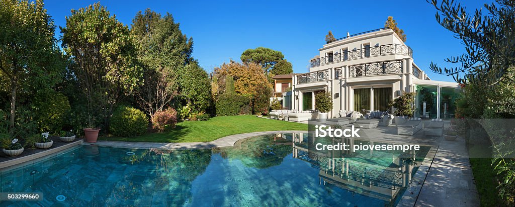 beautiful house with pool Architecture; beautiful house with pool, blue sky and lush garden Luxury Stock Photo