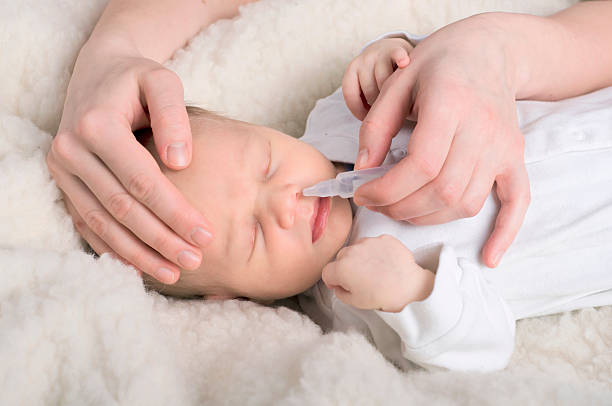 Newborn baby gets nose drops Ill newborn baby gets nose drops human nose stock pictures, royalty-free photos & images