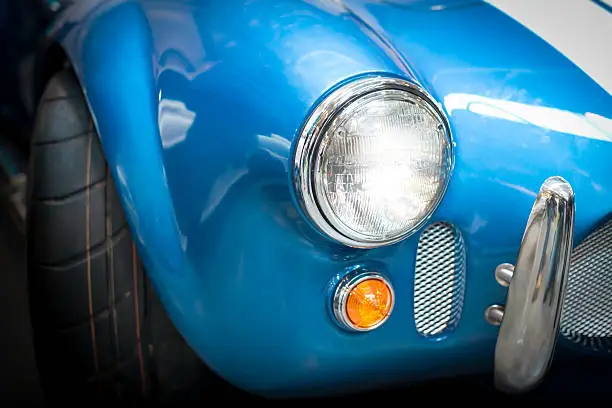 Photo of Headlight Detail of Blue Classic car