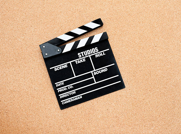 istock Black movie clapper board on wooden background 503305086
