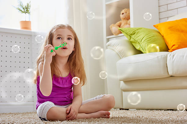 happy niño - bubble child bubble wand blowing fotografías e imágenes de stock