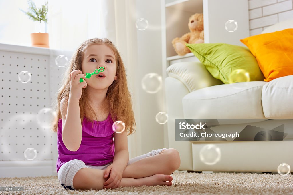 happy child little girl blowing soap bubbles Blowing Stock Photo