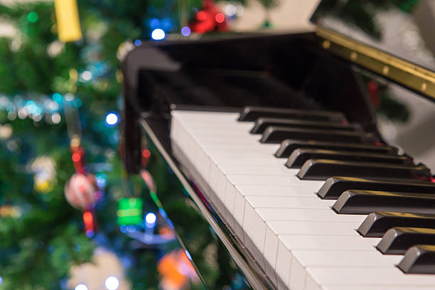 istock Piano with christmas tree background 503310354