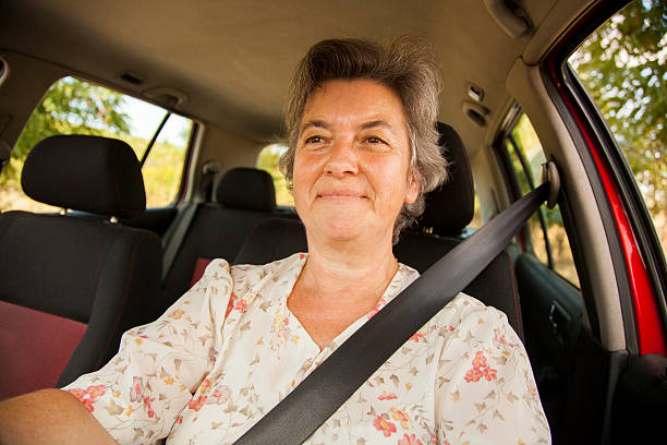 istock senior woman driving red car 503310902
