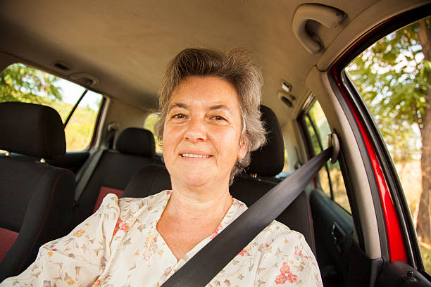 istock senior woman driving red car 503311148