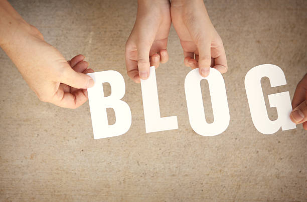 istock Blog - Hands Holding White Letters Over Grunge Background 503311875
