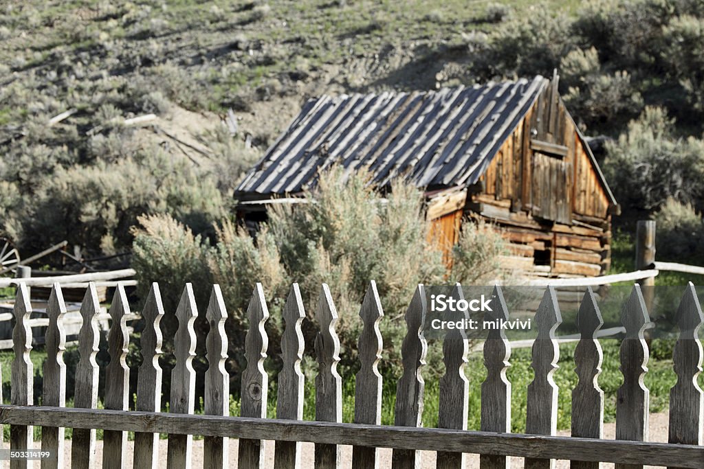 Log Cabin Abandoned log cabin with selective focus on picket fence. Abandoned Stock Photo