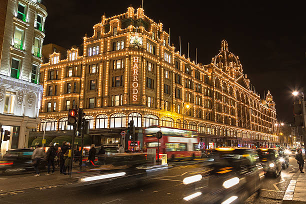Harrods in Knightsbridge at Christmas London, UK - December 23, 2015: The outside of Harrods Department Store in London at night during the Christmas Season. People and traffic can be seen. harrods photos stock pictures, royalty-free photos & images