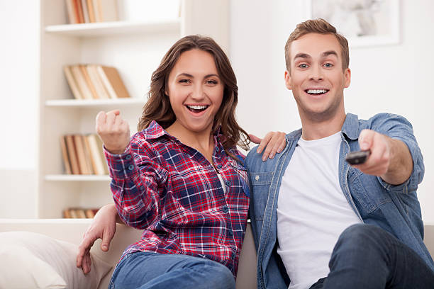 istock Beautiful married couple is entertaining with tv show 503314362