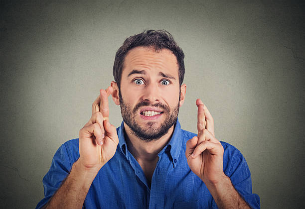 istock Young man making a wish crossing his fingers 503314430