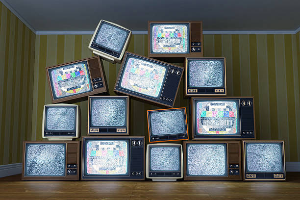 istock Stack of vintage old televisions showing static signal, test pattern 503314473
