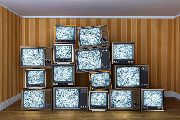 istock Stack of vintage old televisions showing static signal 503314475