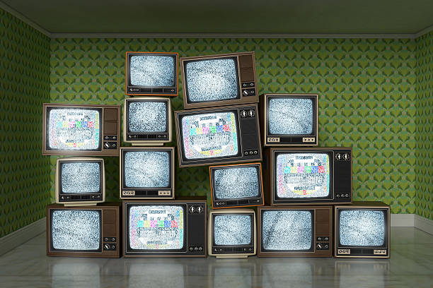 istock Stack of vintage old televisions showing static signal, test pattern 503314479