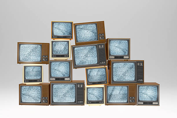 istock Stack of vintage old televisions showing static signal 503314481