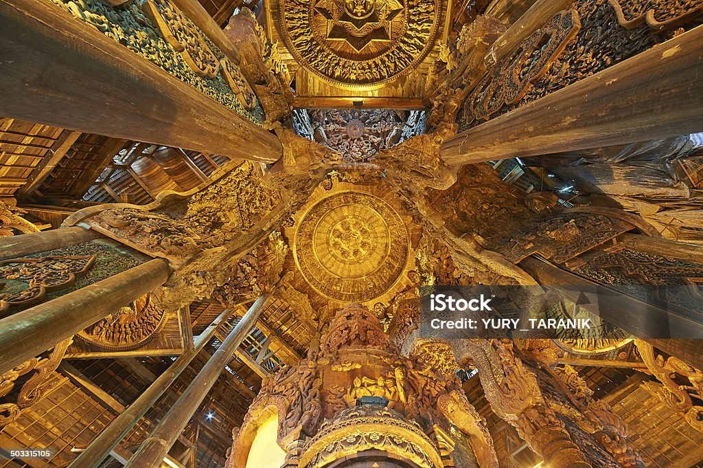 Sanctuary of Truth, Pattaya, Thailand. Sanctuary of Truth is a temple construction in Pattaya, Thailand. The sanctuary is an all-wood building filled with sculptures based on traditional Buddhist and Hindu motifs. Ancient Stock Photo