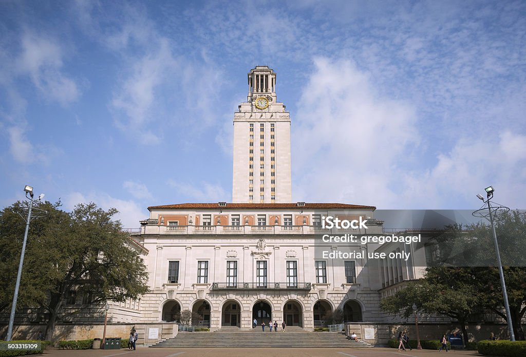 Main Building at the University of Texas campus in Austin Austin, United States - February 17, 2014: People are seen meandering about outside the Main Building, known colloquially as The Tower, on the campus of the University of Texas. The tower is 307 feet tall and has 30 floors. University Of Texas At Austin Stock Photo