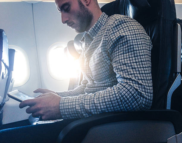 istock Pensive businessman working with digital tablet on the plane 503315761