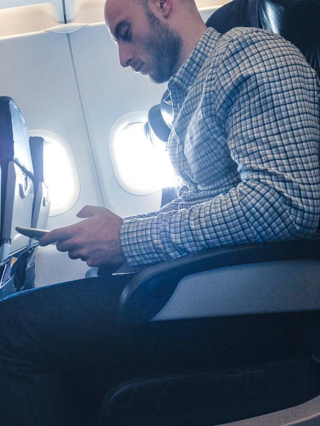 istock Pensive businessman working with digital tablet on the plane 503315763
