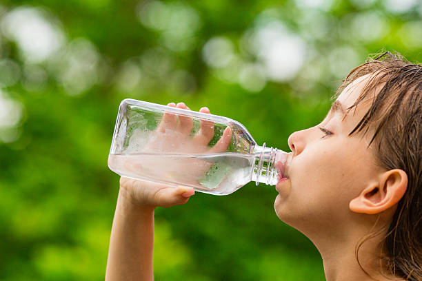 istock Girl drinking clean tap water from transparent plastic bottle 503325142