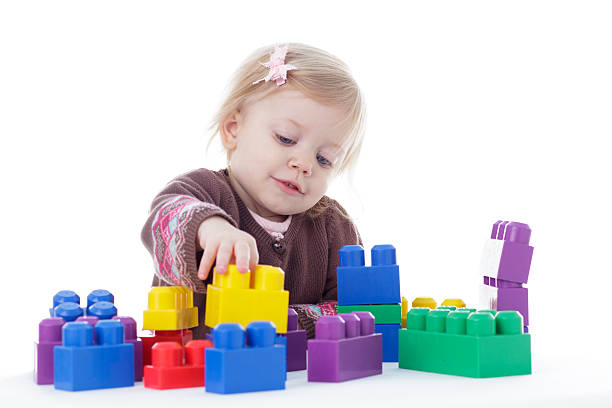 istock toddler girl playing with colored building blocks 503327214