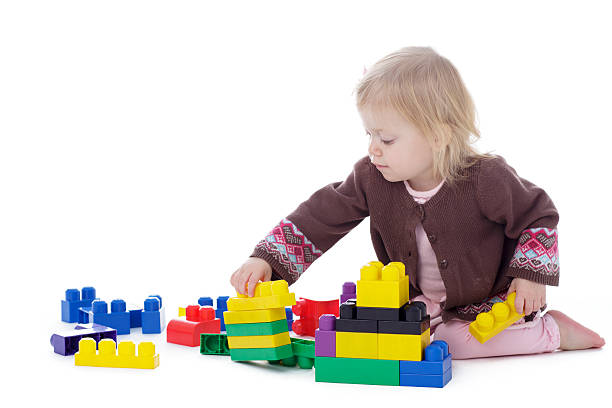istock toddler girl playing with colored building blocks 503327522