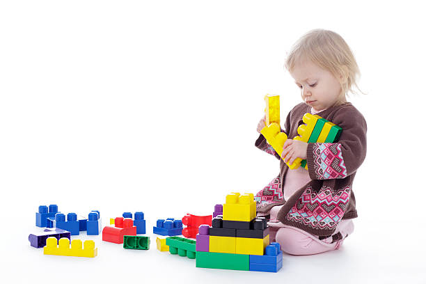 istock toddler girl playing with colored building blocks 503327570